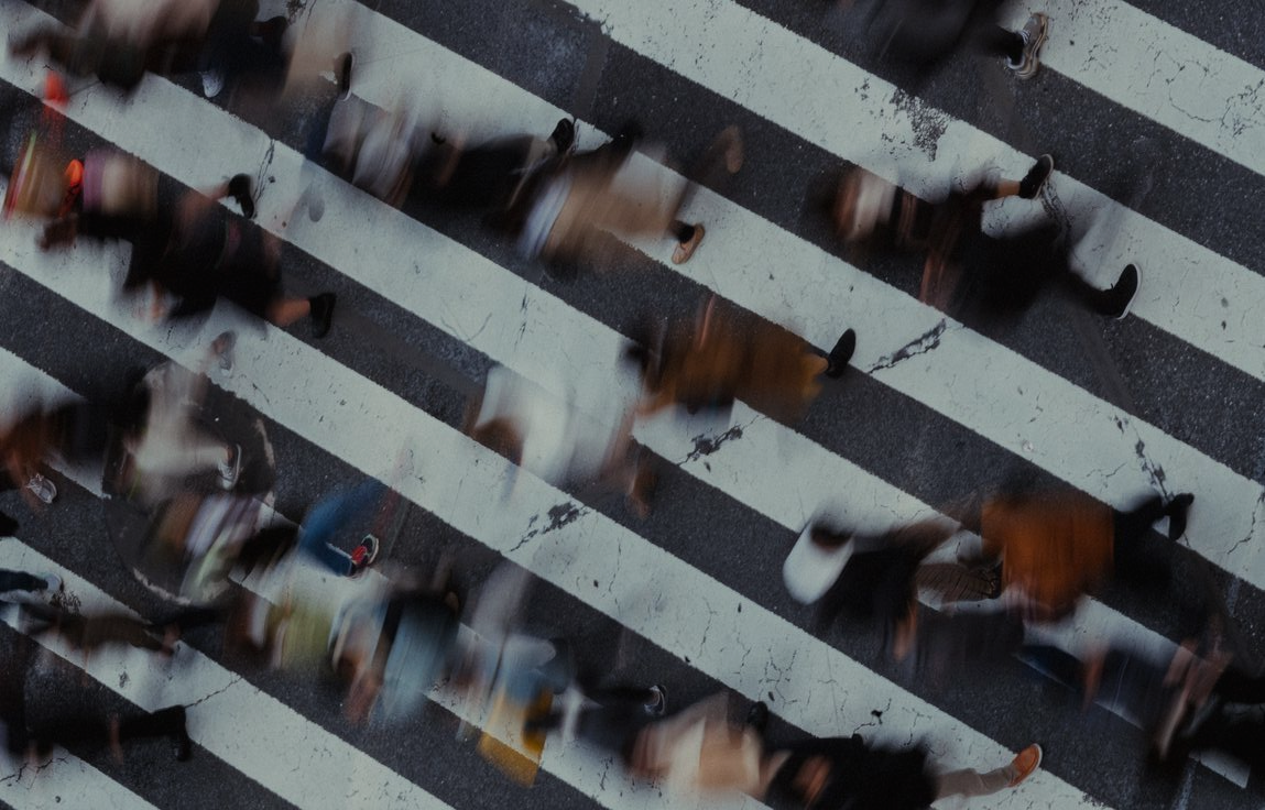 Aerial view of a crosswalk filled with people in motion blur